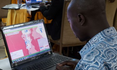 An attendee at an Ebola workshop in Ghana reviews IHME data.